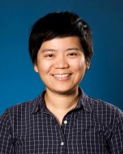 Pei-Shan smiling wearing a blue and white checked shirt